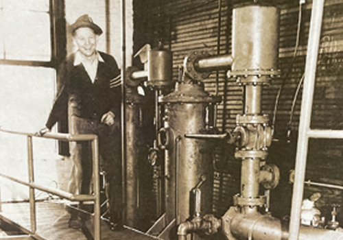 Historic image of people with mechanical equipment.